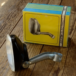 Scheinwerfer "FER / AKA ELECTRIC", Kunststoff schwarz, B=75/75mm, L=40mm, incl. Halter, orig. Altbestand 